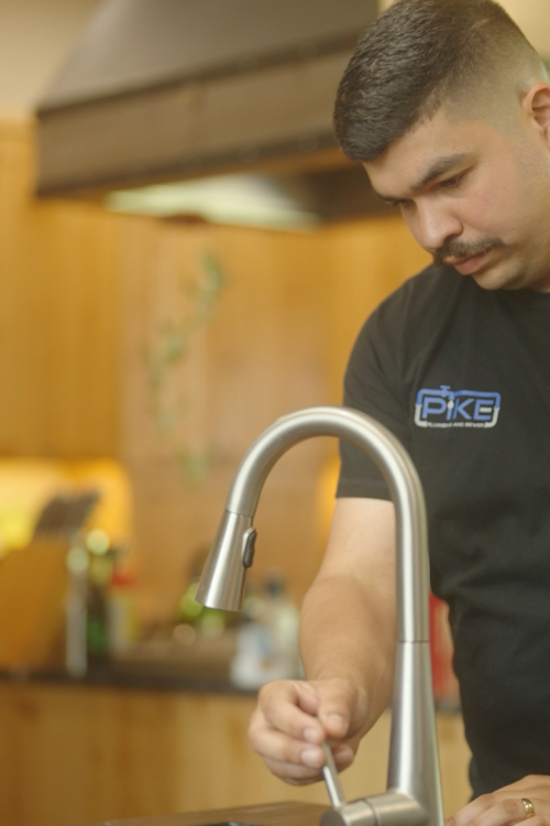 Image of Anthony turning on water