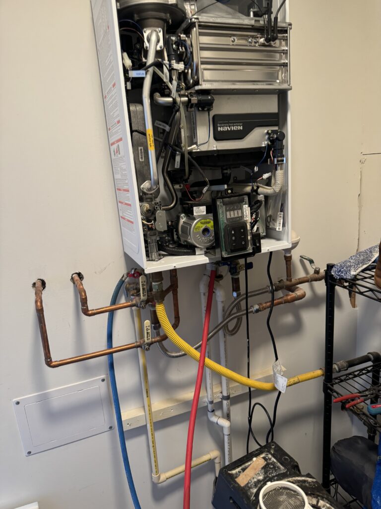 Plumber in Pacific WA installing a new water heater for a homeowner