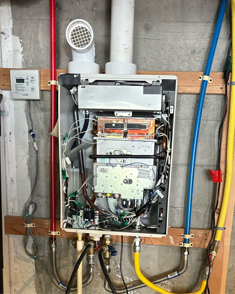Tankless Water Heater with cover off for maintenance